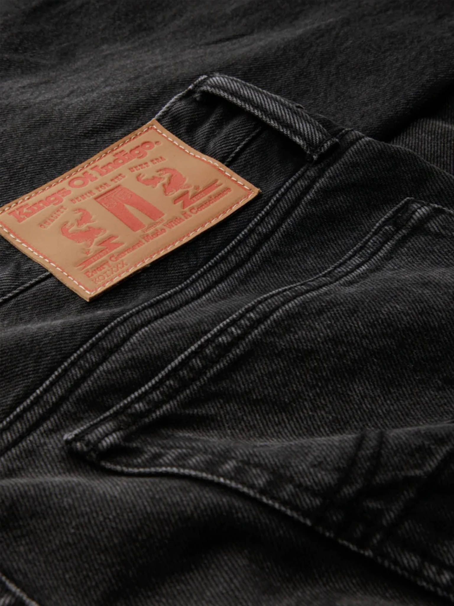 Kings of Indigo Jerrick Recycled Night Jeans close up of brand patch on the waist at back.