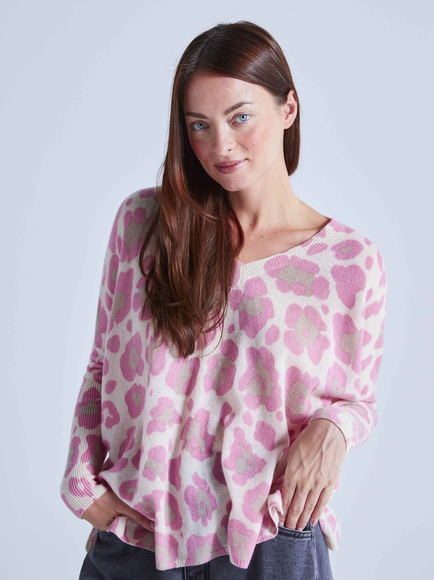 Model Wearing Absolut Cashmere Camille V-Neck Leo Pink Poncho Jumper from the front