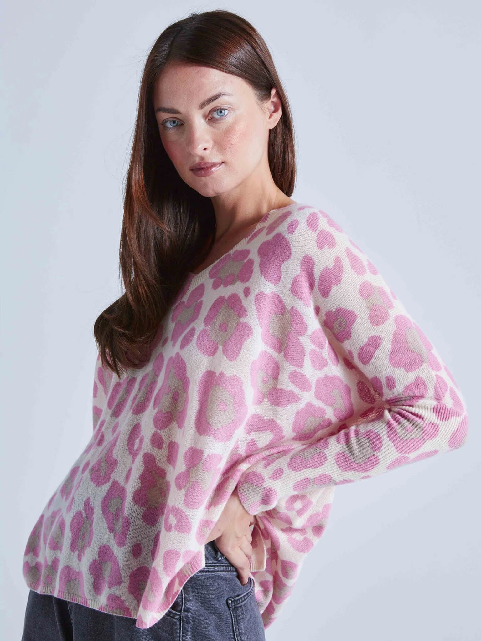 Model Wearing Absolut Cashmere Camille V-Neck Leo Pink Poncho Jumper from the side