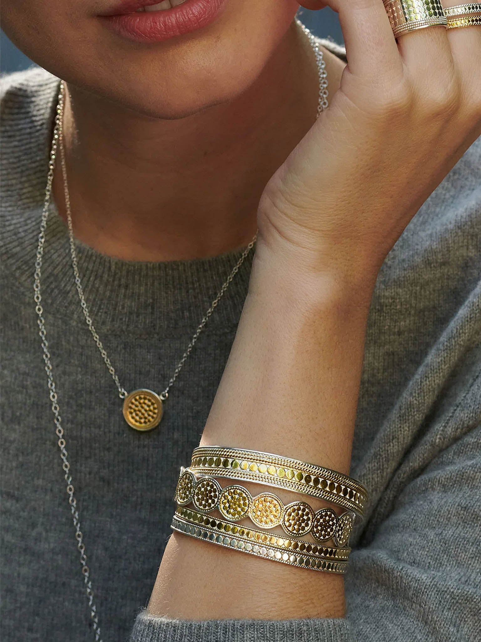 Anna Beck Classic Multi-Disk Gold Bracelet Cuff on model with many other items of jewellery