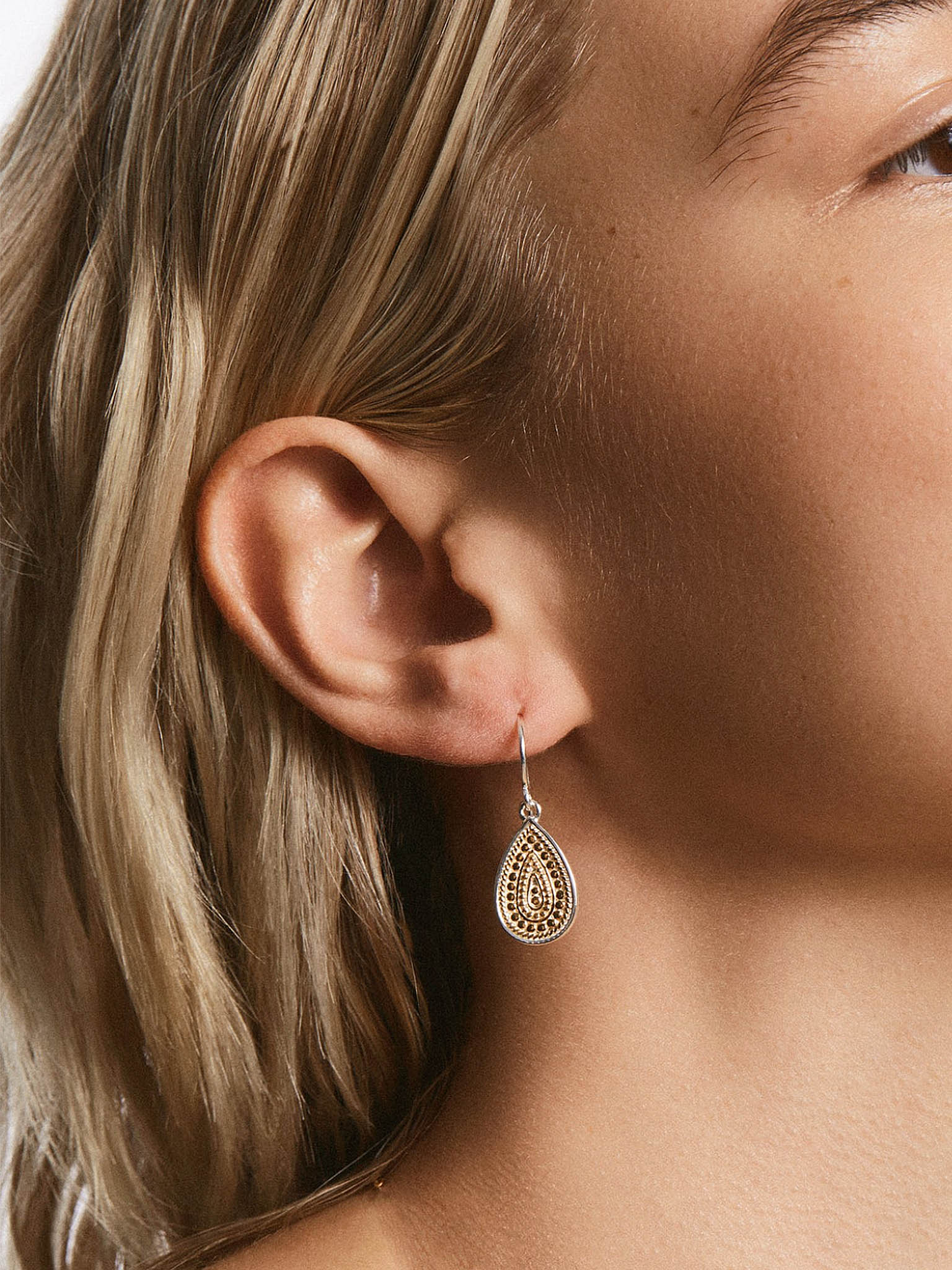 Anna Beck Classic Tear Drop Gold Earrings on models ear side profile