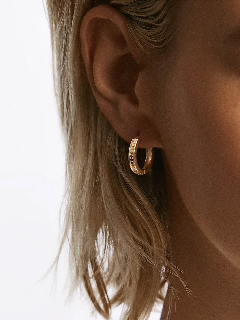 Anna Beck Small Hinge Reversible Hoop Earrings close up on models ear