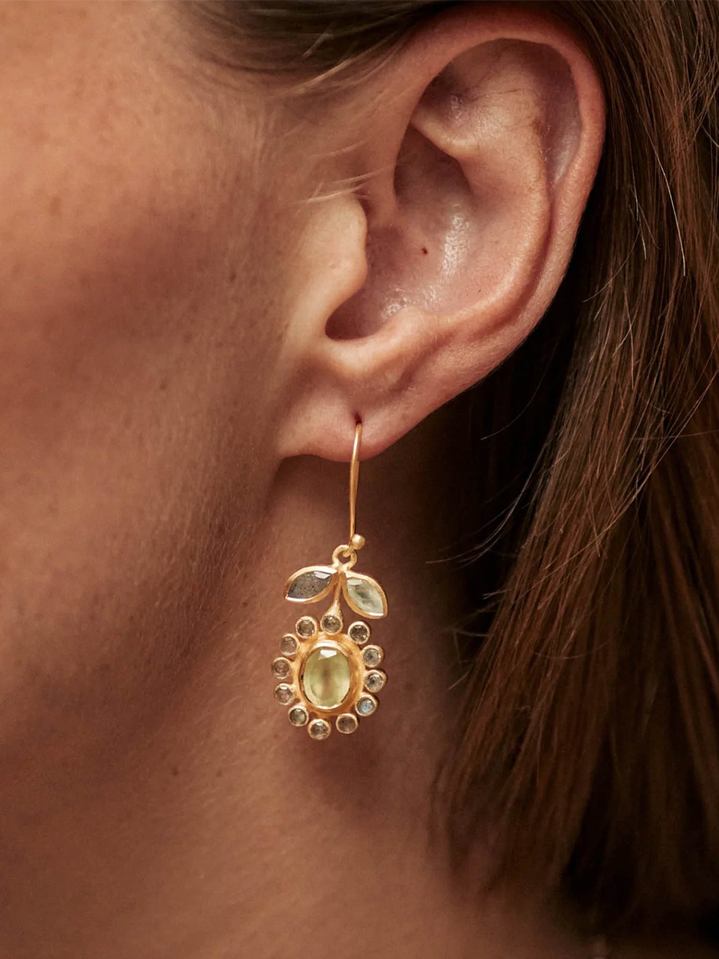 Close up of a ladies ear wearing a Carousel Jewels Jackie Flower Earring