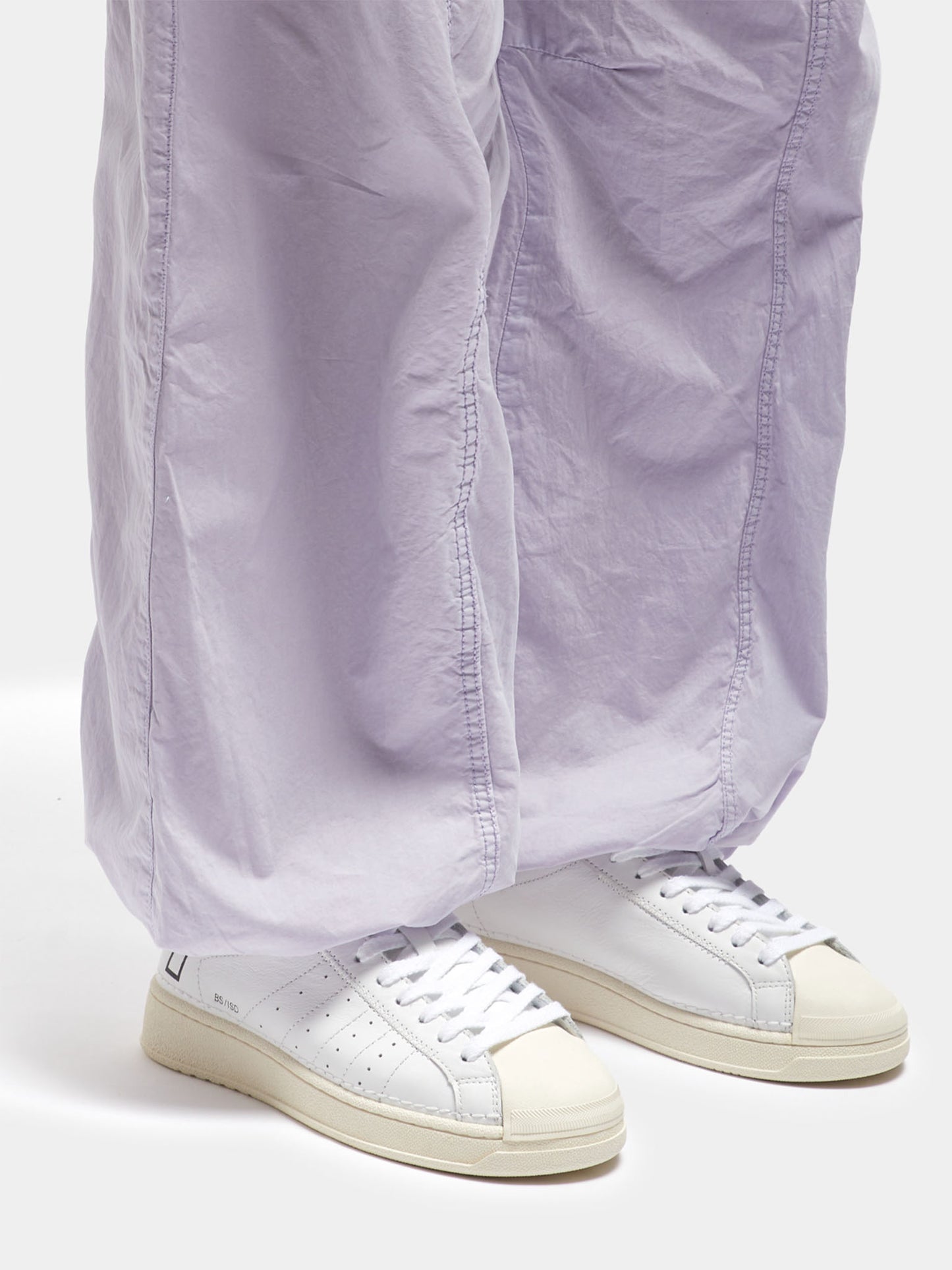 D.A.T.E Base Island White Cream Trainers on model wearing lilac trousers