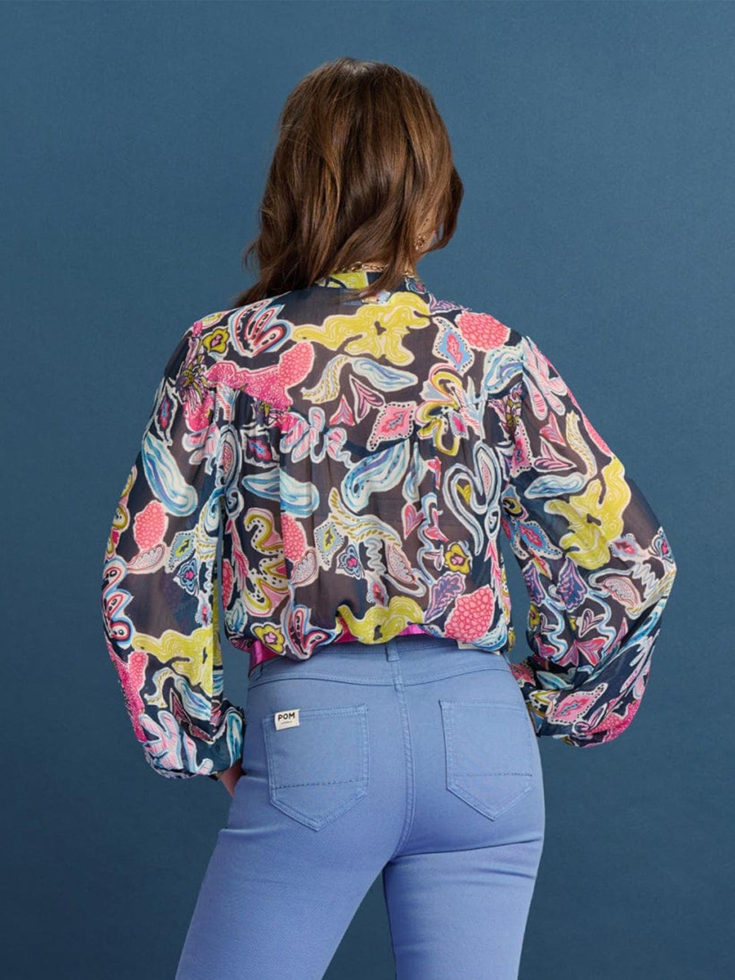POM Amsterdam Full Glow Deep Blue Blouse from the back paired with light blue jeans